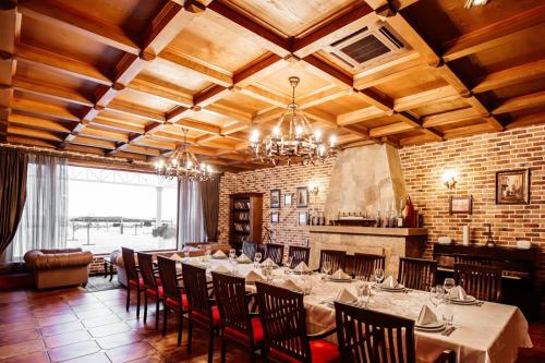 restaurant private room with table for 14 persons wooden ceiling brick walls and fireplace